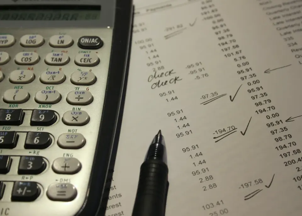 An accounting report and payment card on a desk, used to review invoices
