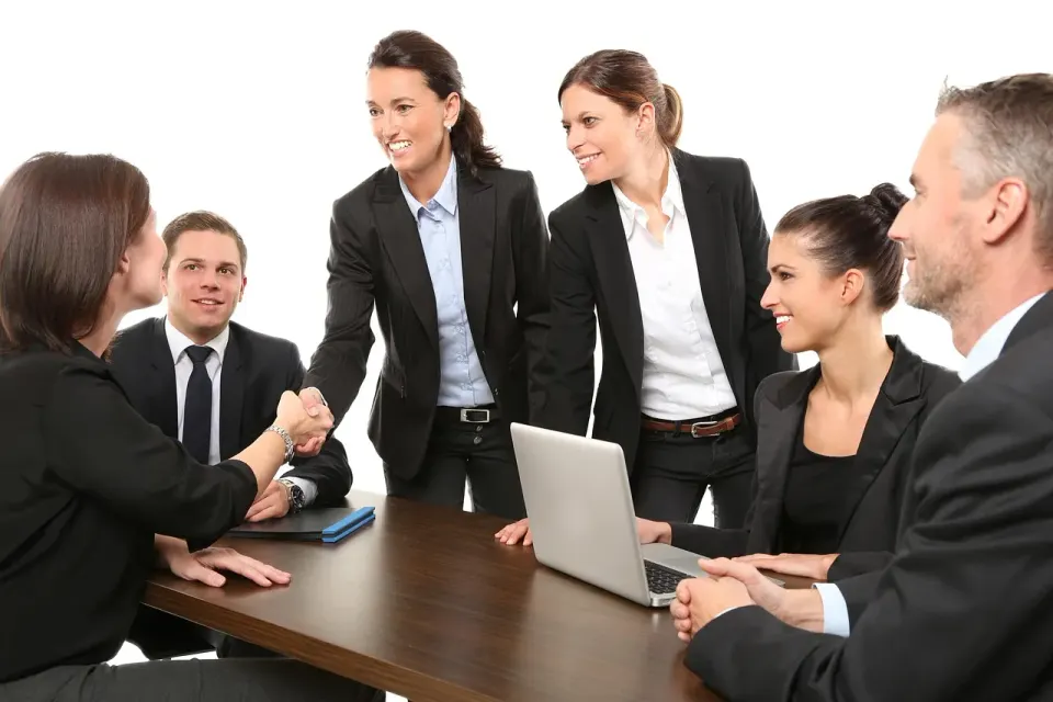 Business people meeting around a table with laptops