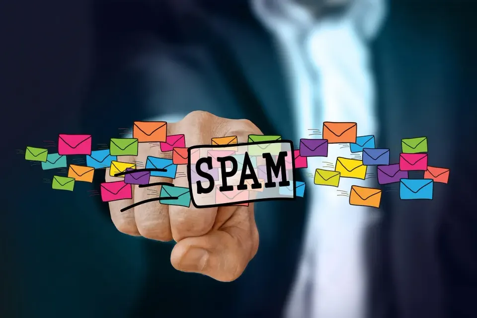 A hand holding a letter next to an email icon