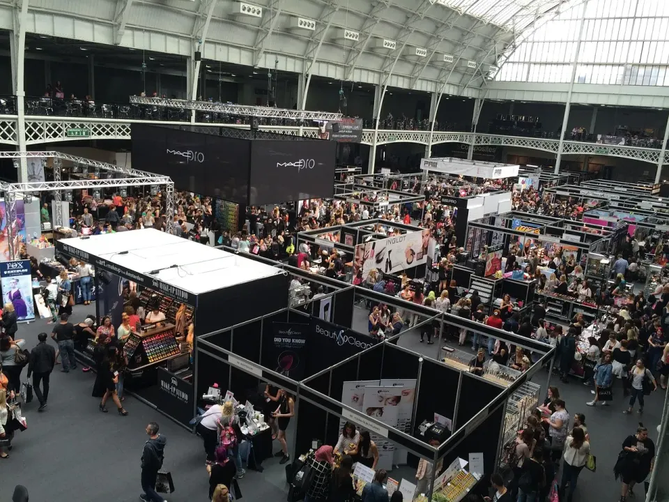 Visitors walking between booths in a trade show exhibition hall