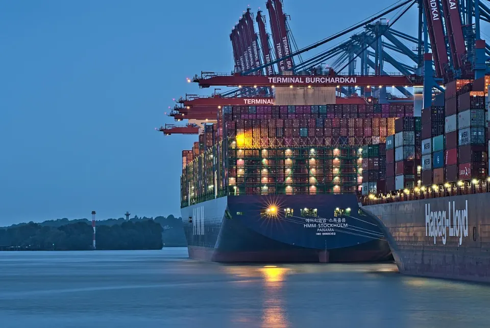 Cranes and a container ship at a busy freight port