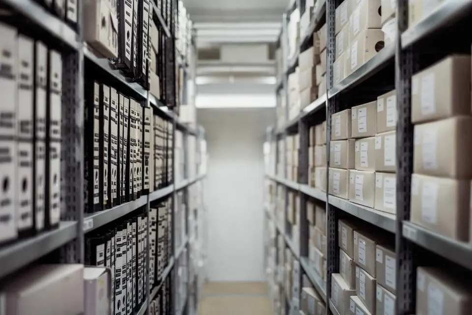Archive boxes and folders stacked on shelves