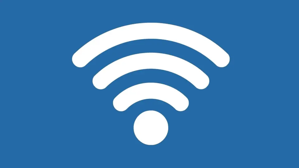 A wireless Wi-Fi router with antennas on a desk