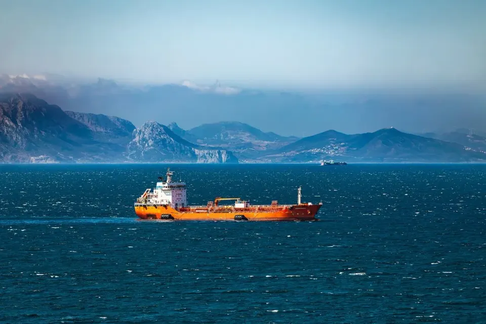 A large cargo ship sailing across open sea