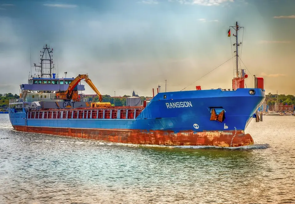 A freighter moored in a harbor next to the quay