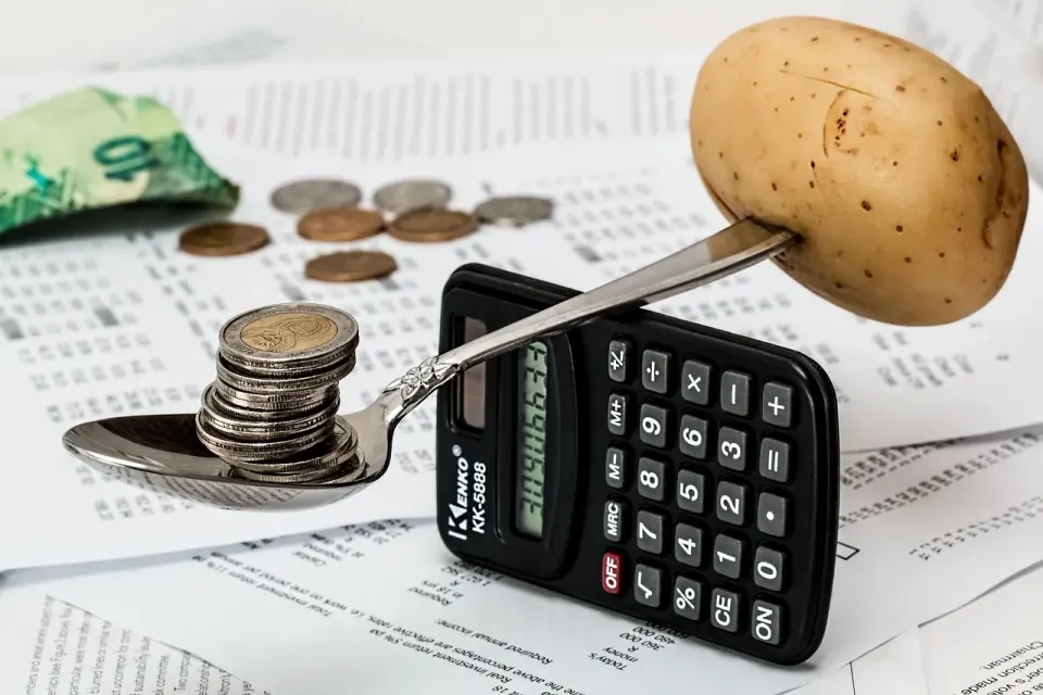 Coins and a calculator used for household budget planning