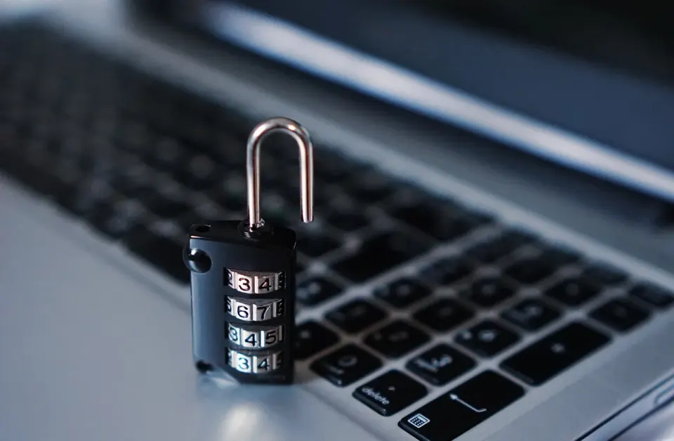 A padlock resting on a laptop keyboard for cyber security