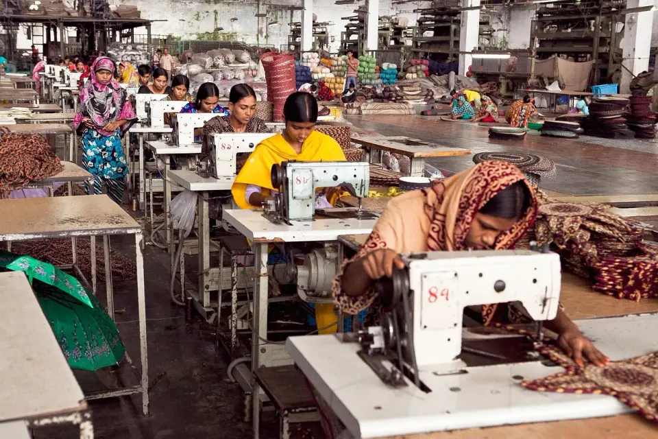 Women working at sewing machines on a garment factory floor